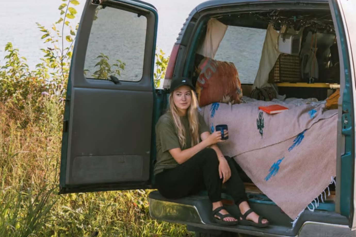 road tripper having coffee in her van