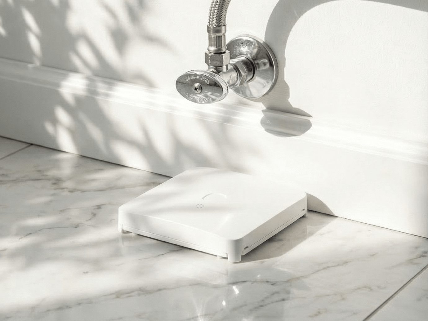 Smart Leak and Freeze Detector placed under a water pipe