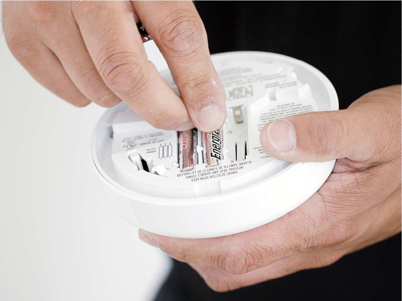 Man installing smoke alarm