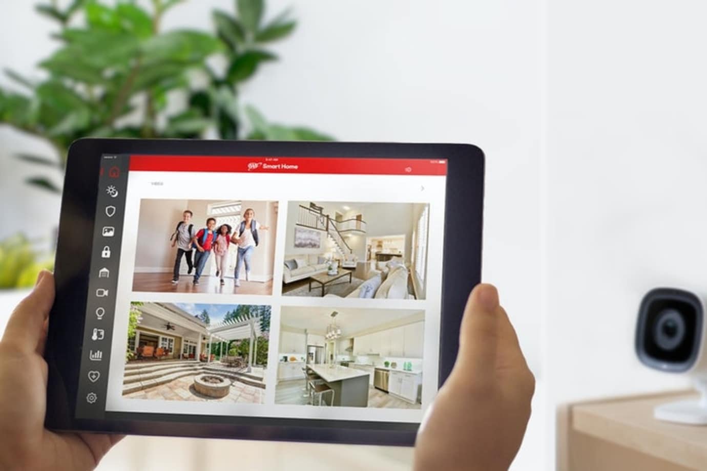 A AAA Smart Home customer monitors her home on a tablet