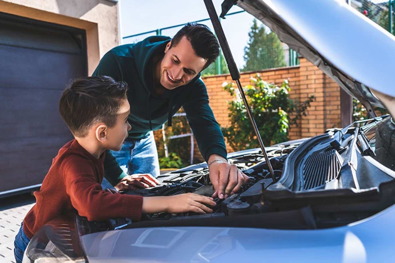 a AAA insurance customer checks the oil levels of his car