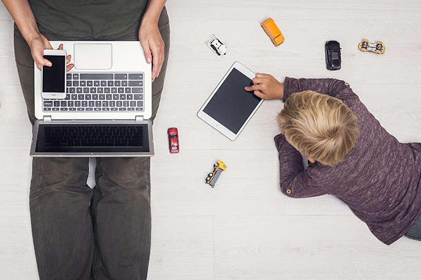 A mother with ProtectMyID from Experian uses technology at home with her son 
