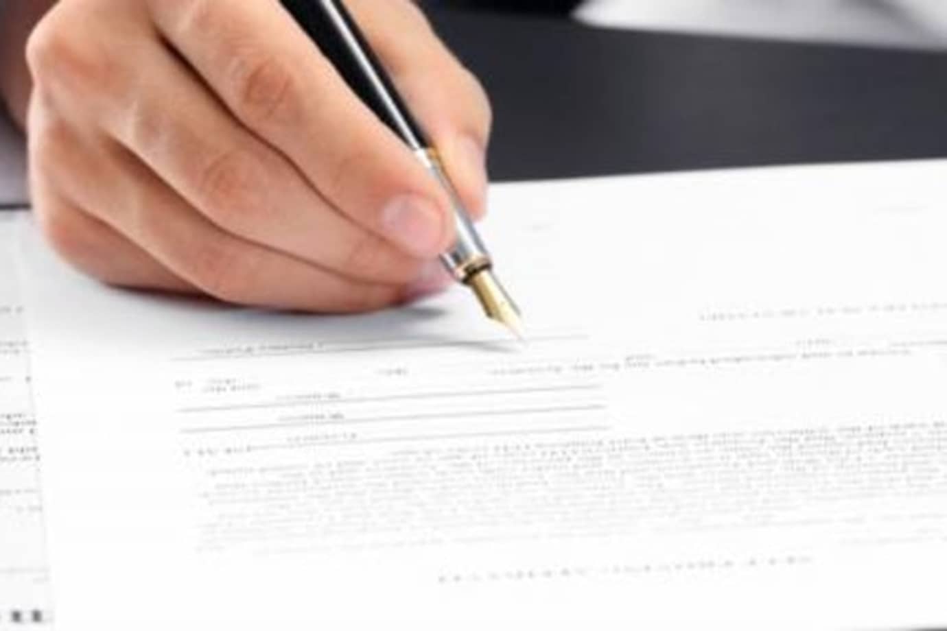 a AAA member signs DMV forms for a notary at the AAA office