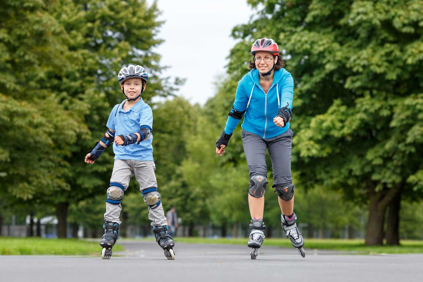 A AAA Term Life Insurance customer teaches her son how to rollerblade