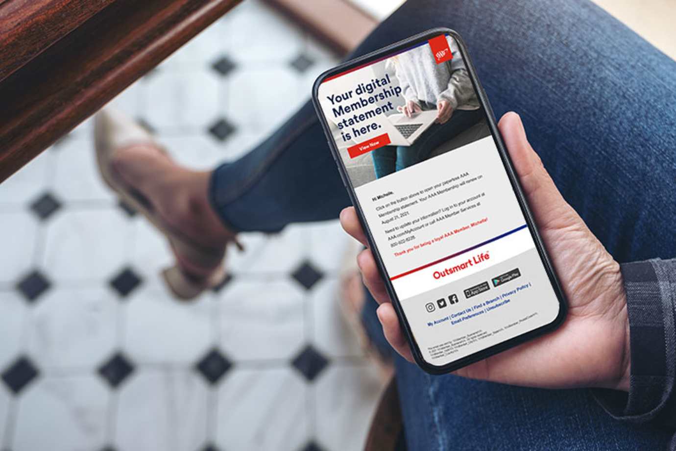 a AAA Member with paperless Membership looks at email on her phone.