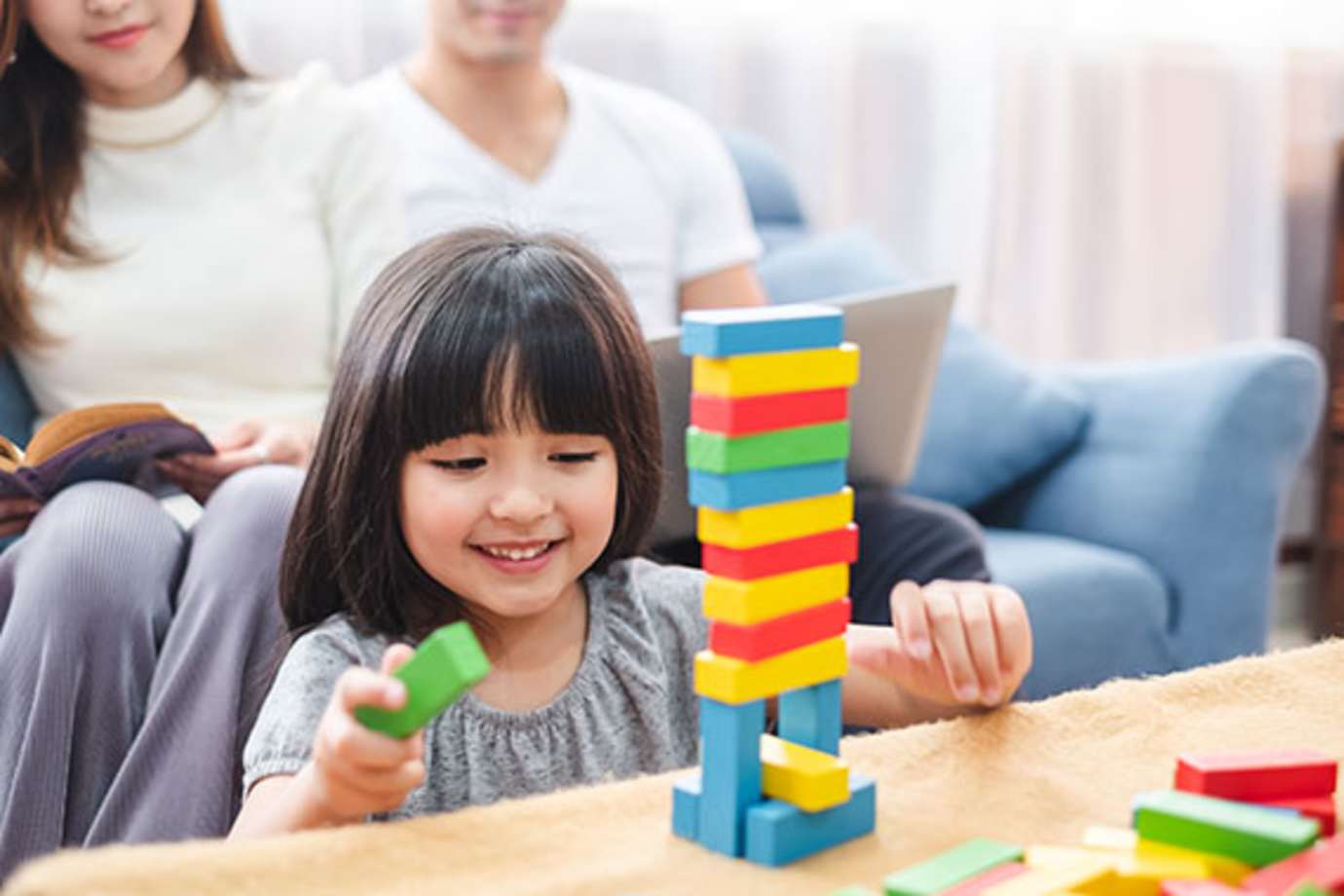 a girl plays with legos in her house insured with AAA