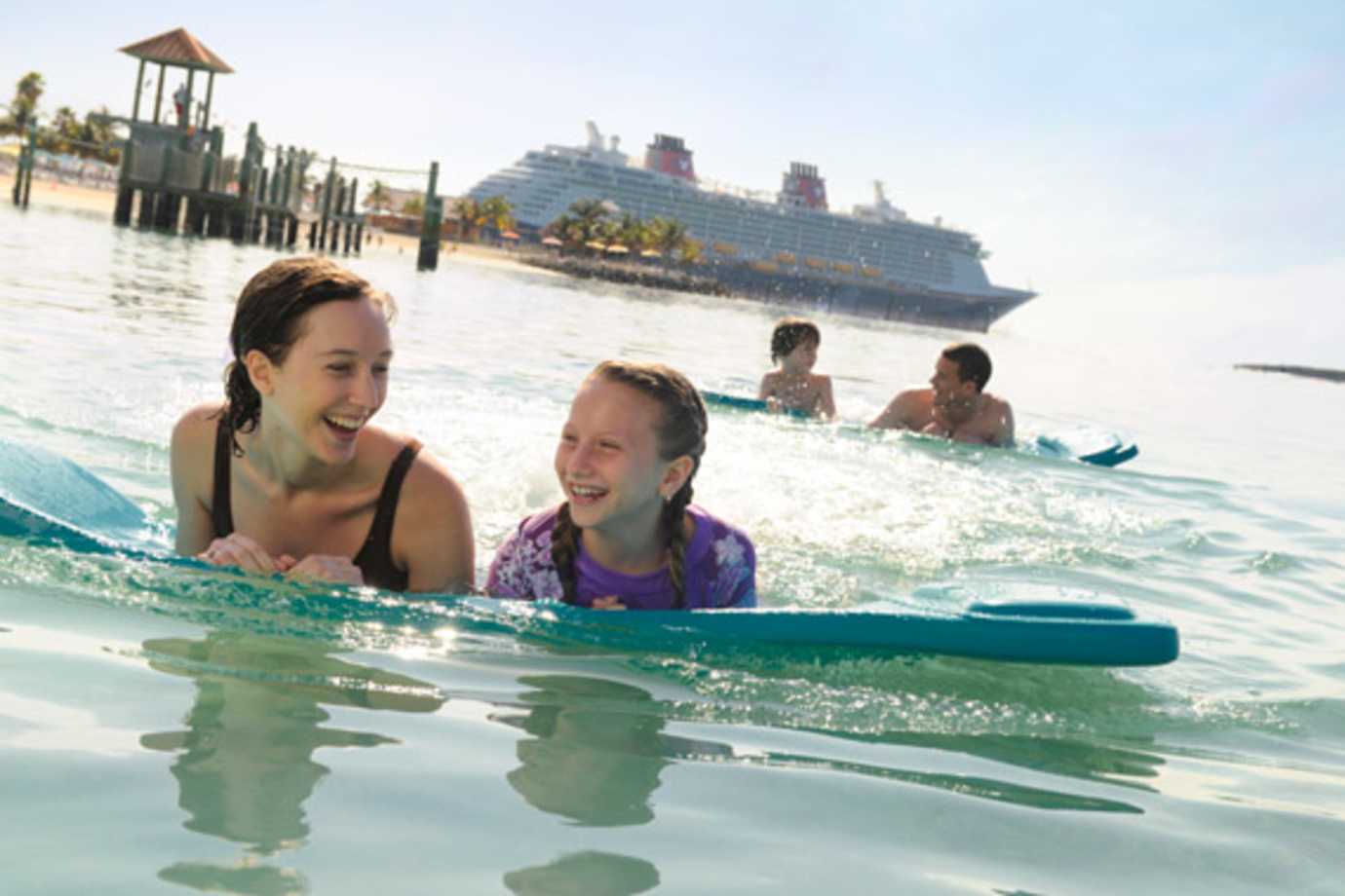 disney cruise line ship and guests at castaway cay