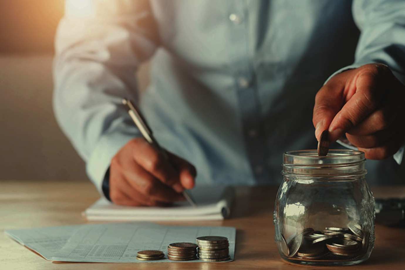A AAA Member adds up savings in a change jar