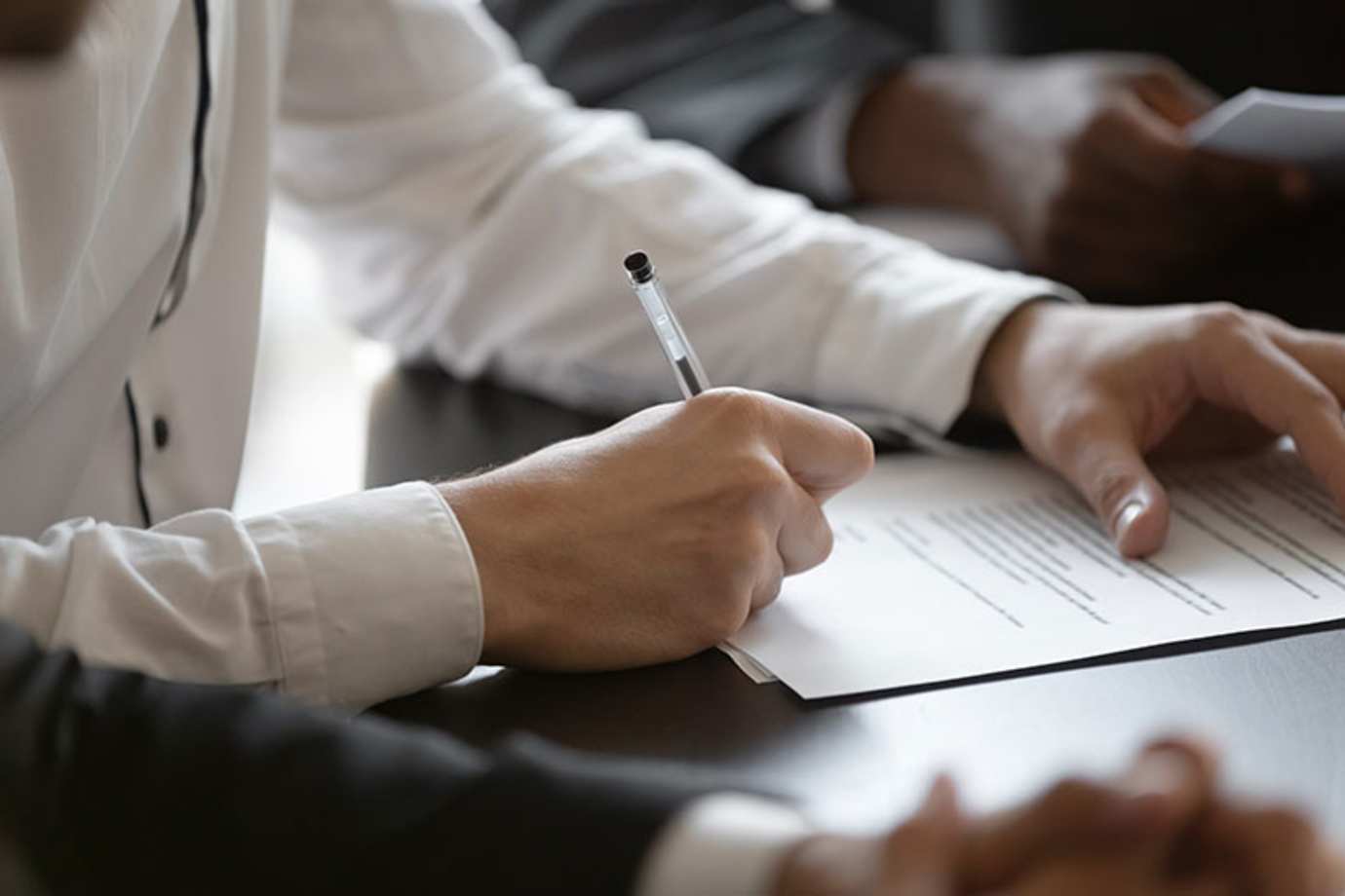 a AAA Member signs documents for notarization 