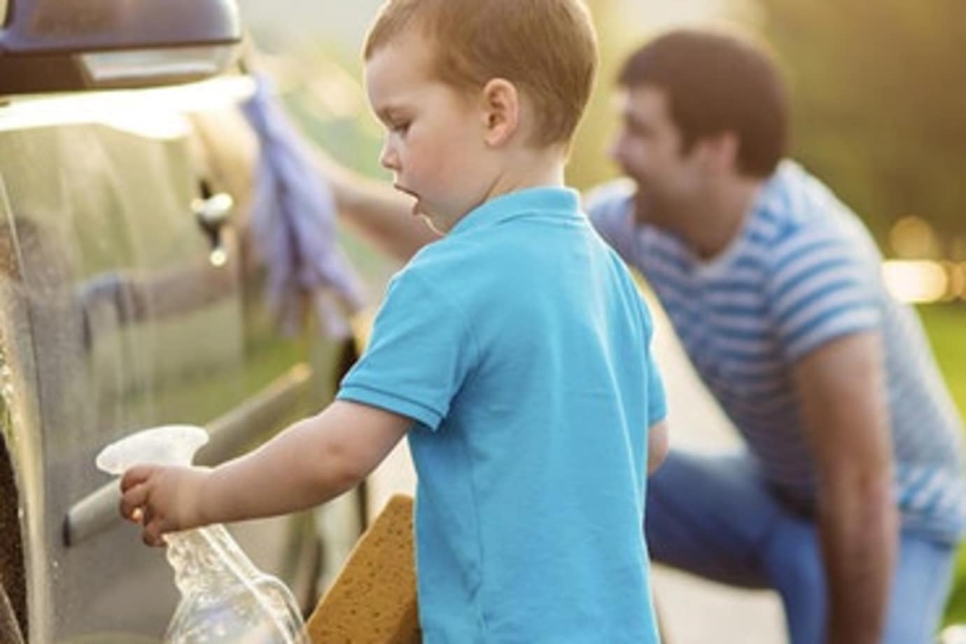 a father with aaa insurance washes his car