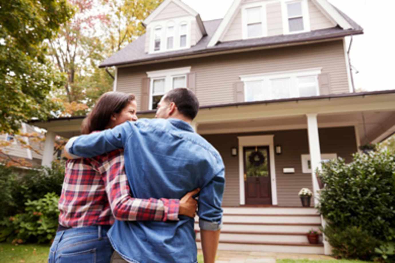 California homeowners look at their house insured by AAA