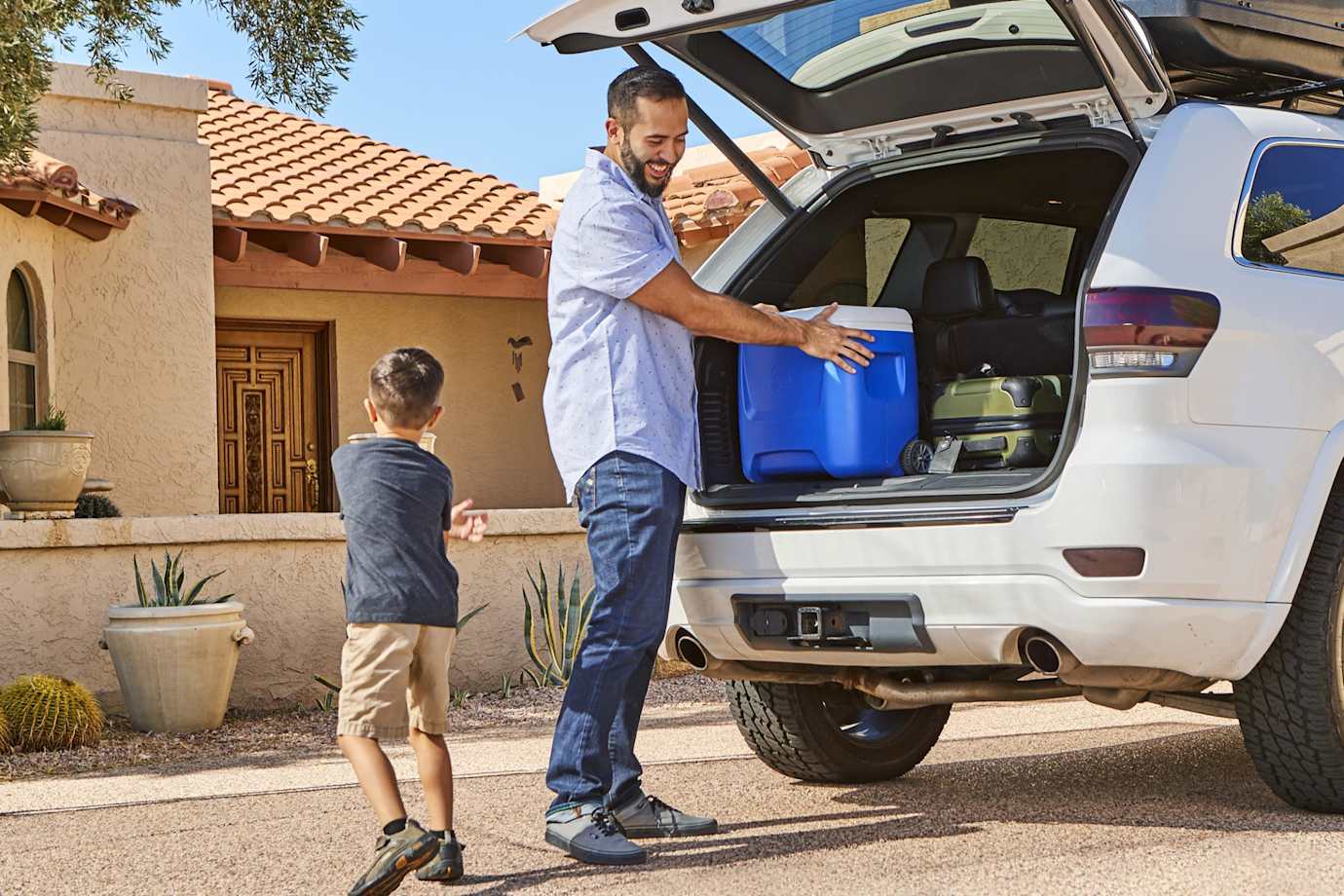 Father and son packing up the car