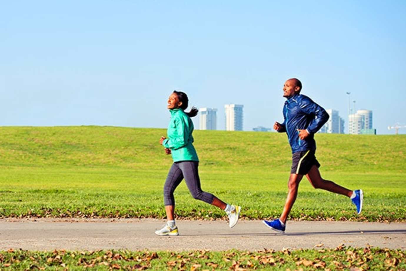 two runners insured with aaa term life insurance jog along a path