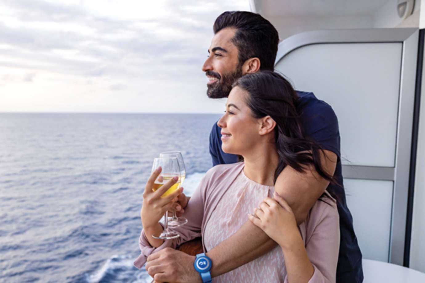 couple with wine on balcony of stateroom on princess cruise ship