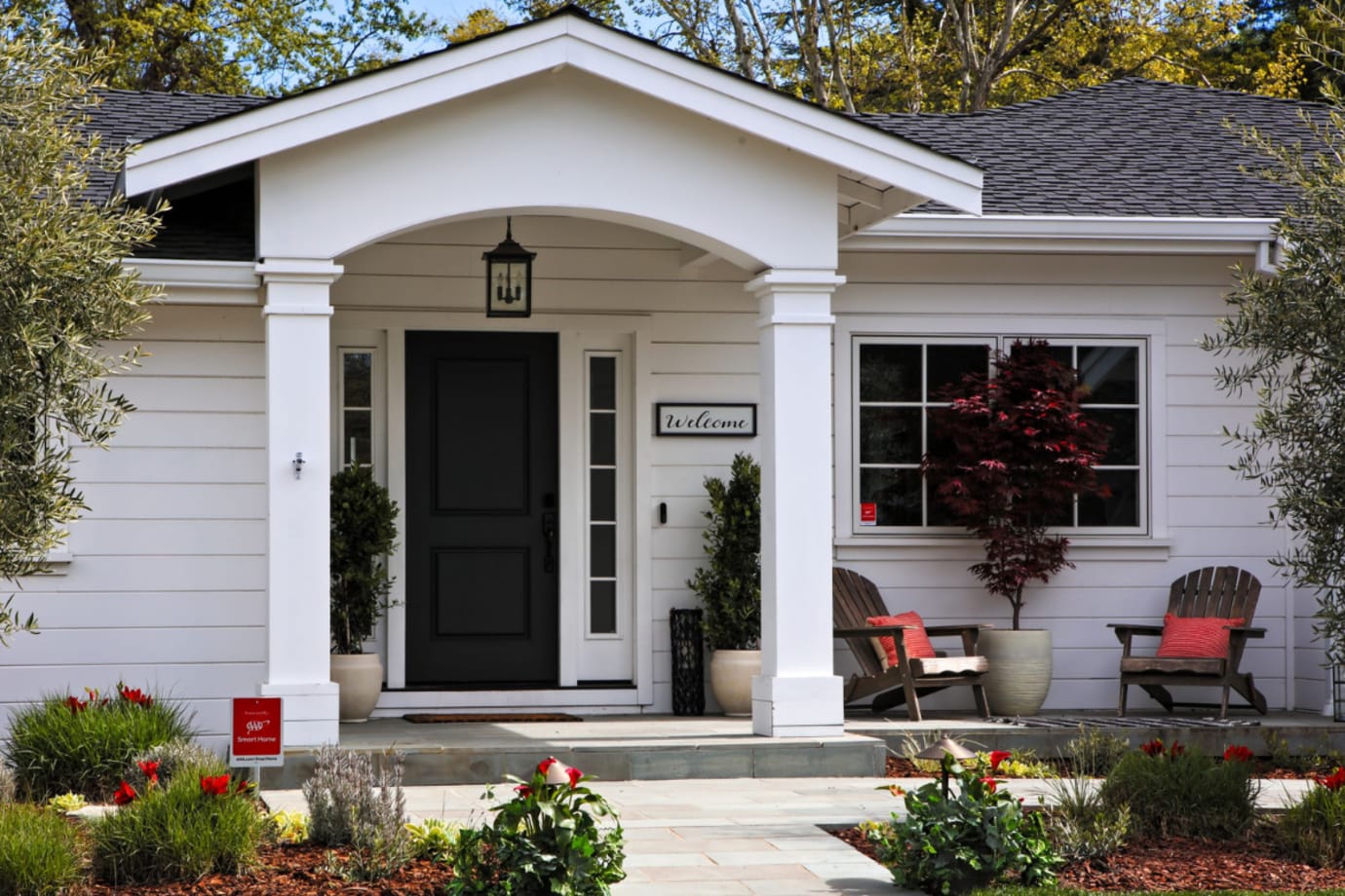 a modern house with a AAA yard sign