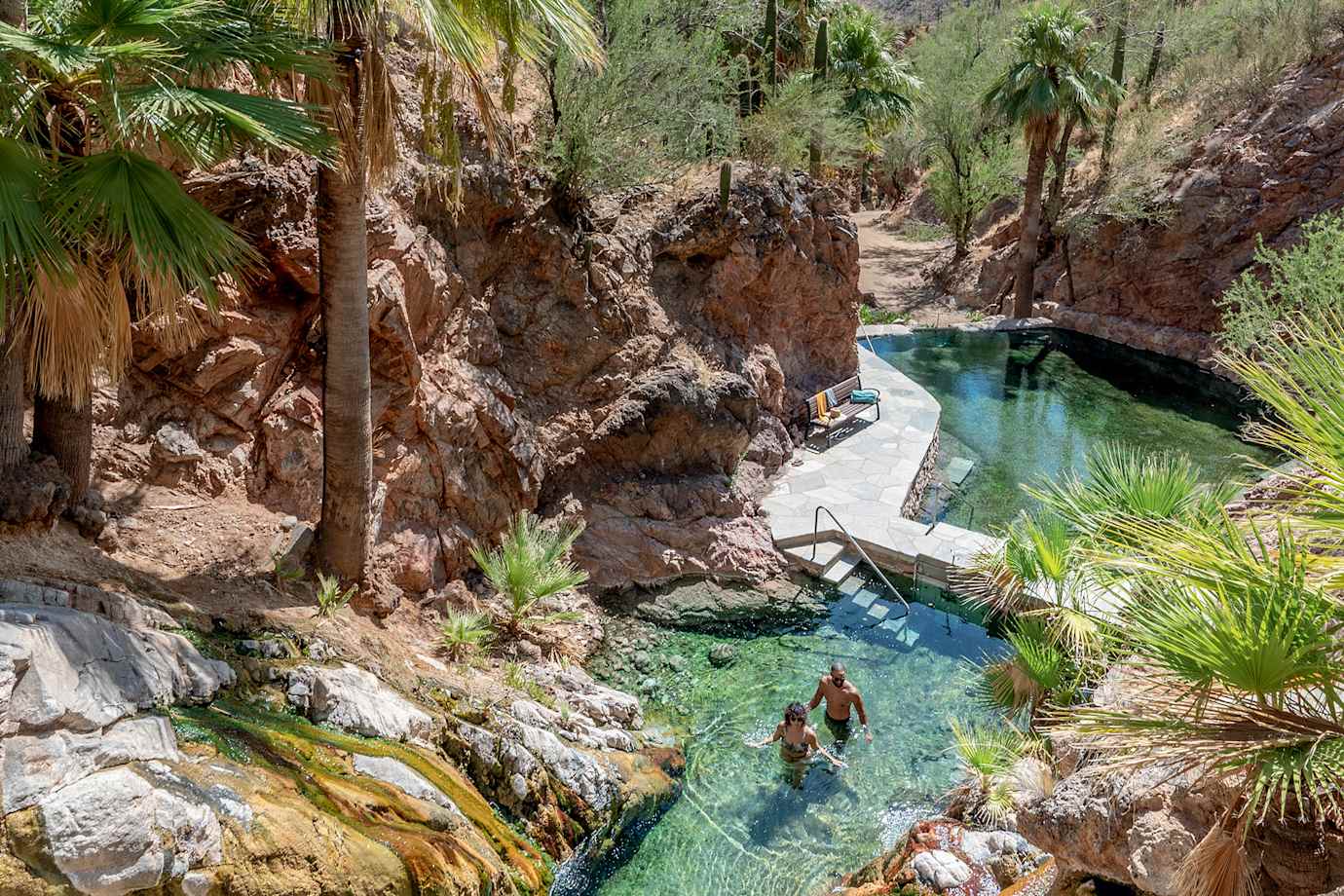 Two people soak in Castle Hot Springs in Morristown, Arizona.