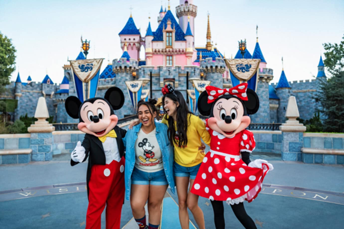 see a statue of walt disney and mickey mouse at disneyland on a disney vacation