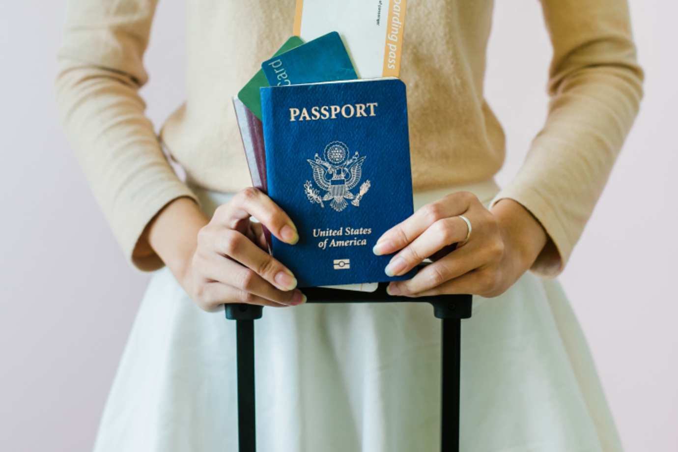 Someone with a passport gets ready to board a plane