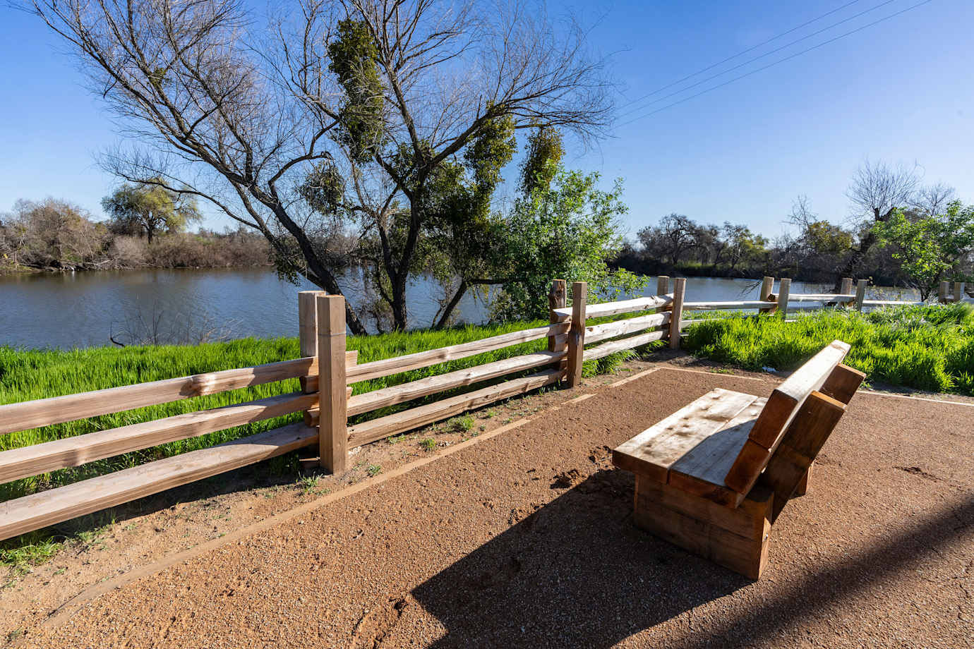 A bench overlooks the pond at Dos Rios State Park in California.