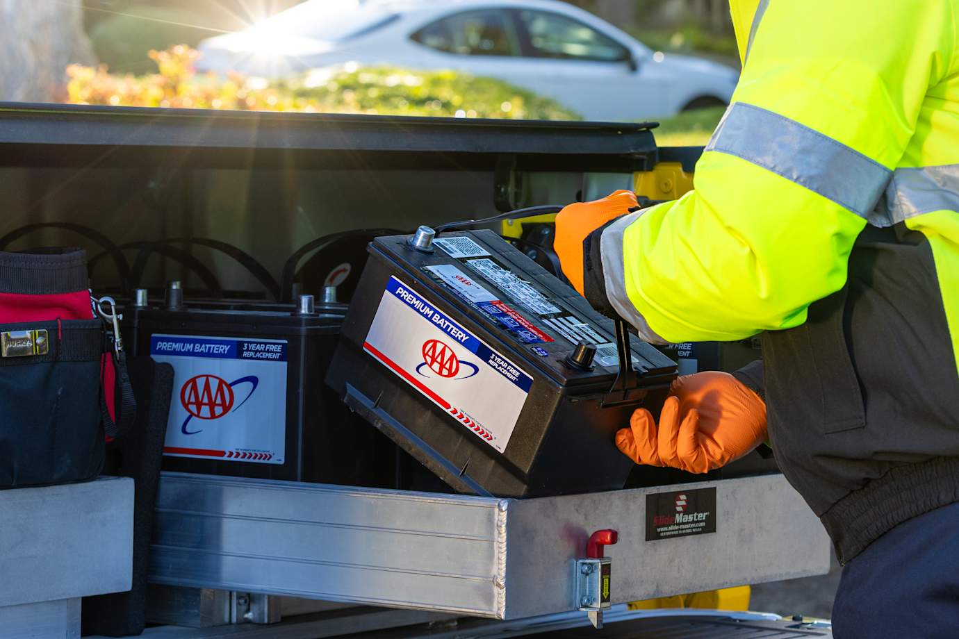 AAA technician placing AAA battery in service truck