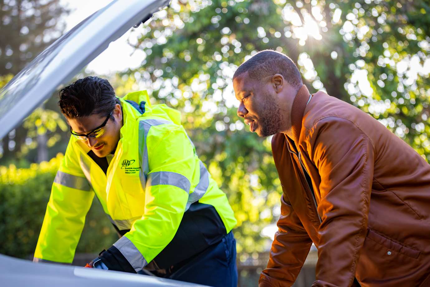 AAA Member shakes hands with roadside technician