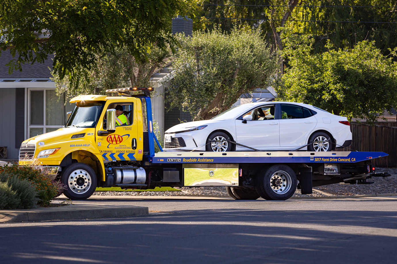 AAA tow truck towing an electric vehicle