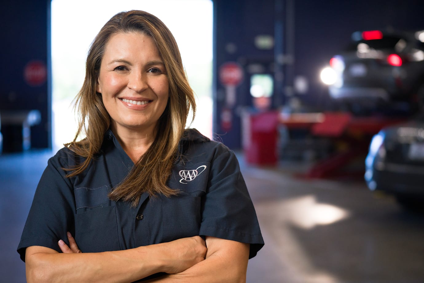 AAA auto repair center ASE-certified technician smiles