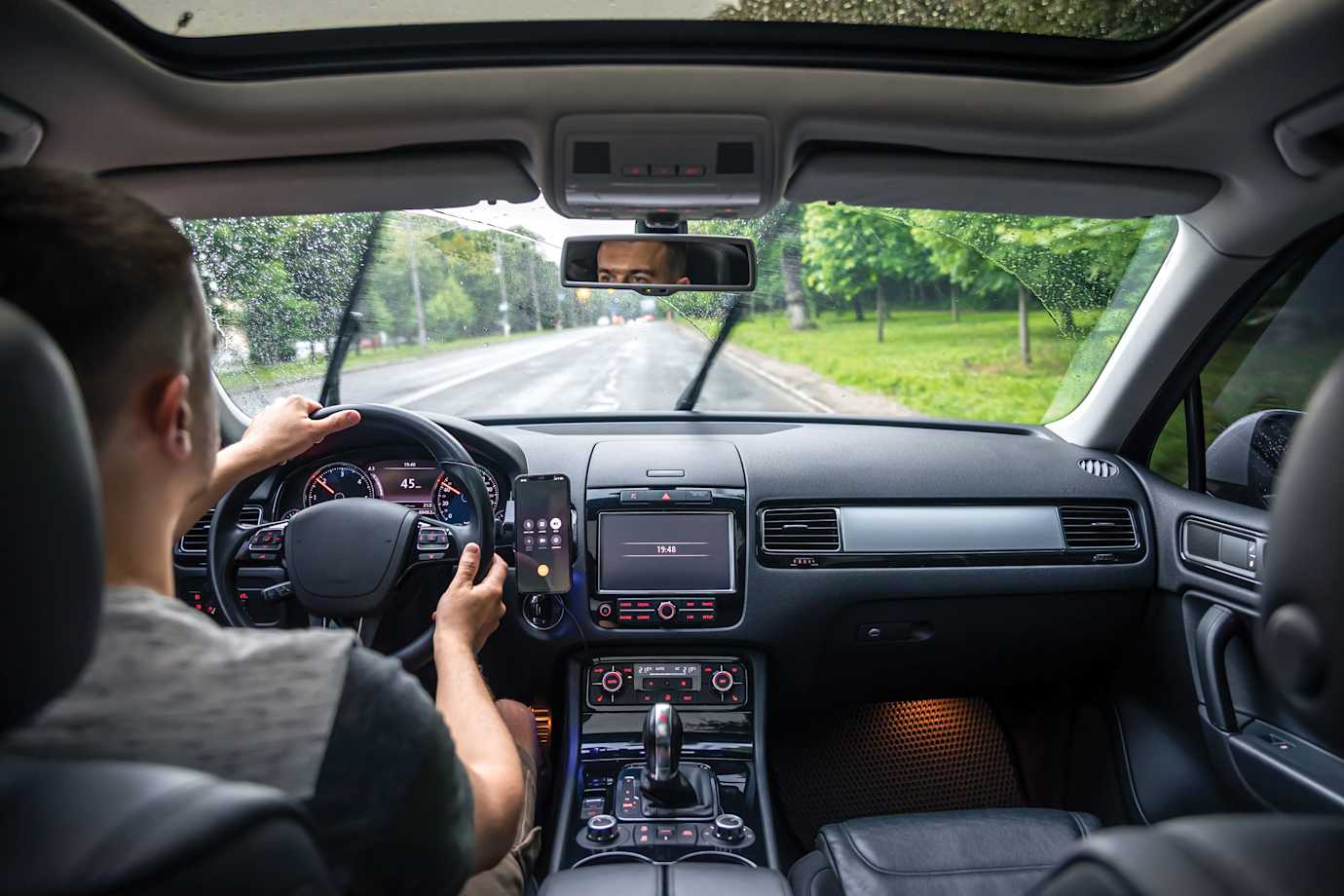 A driver practices road safety in the rain