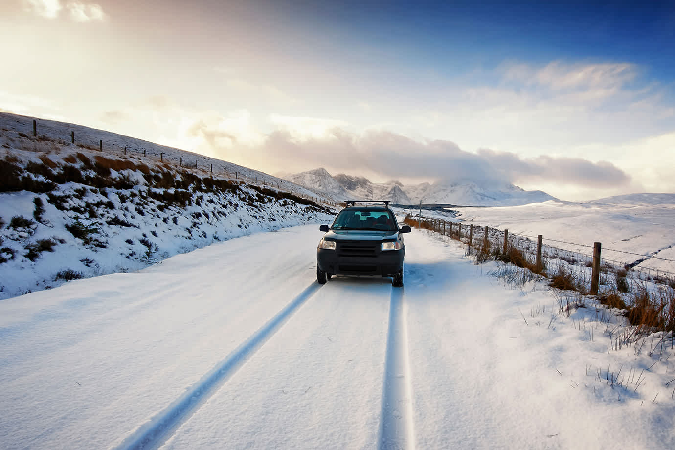 suv driving on a snowy road