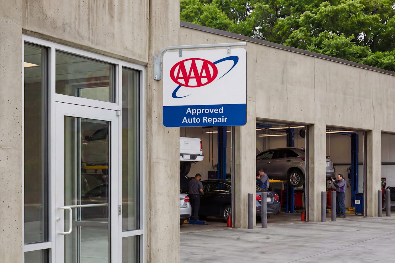 the storefront of a AAA Approved Auto Repair shop with the garage doors open