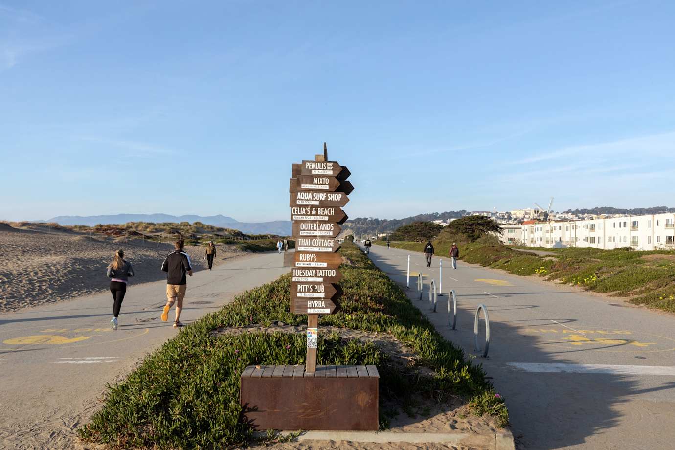 People enjoying the sunny day at Sunset Dunes park near Judah St. in the Outer Sunset District of San Francisco.