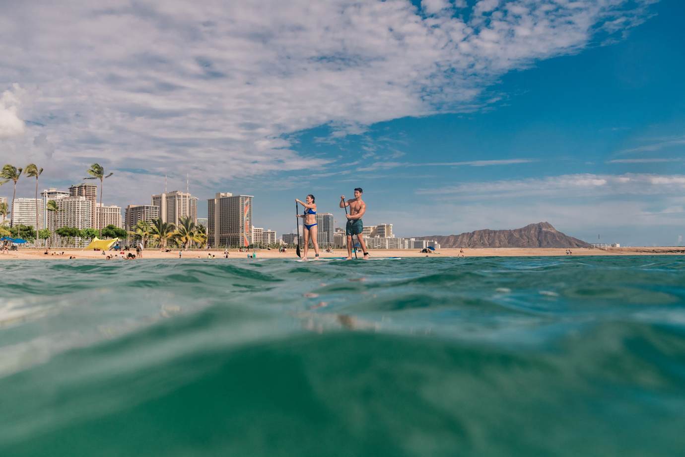 couple paddleboarding in hawaii