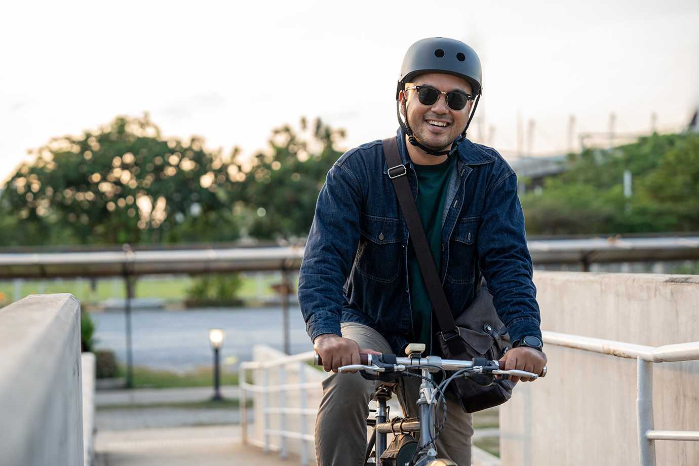 Someone on a bike smiles because they know they're covered with accident insurance through AAA