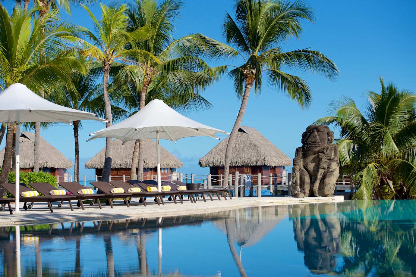 pool and umbrellas at manava beach resort
