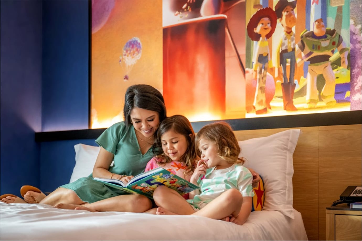 family in bed at disneyland hotel for hotel offer