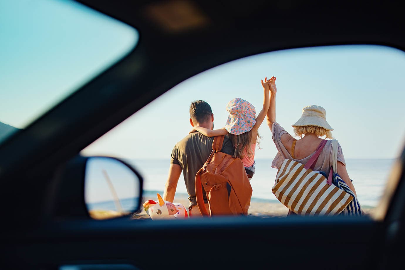 Hertz car rental window view of a family headed to the beach