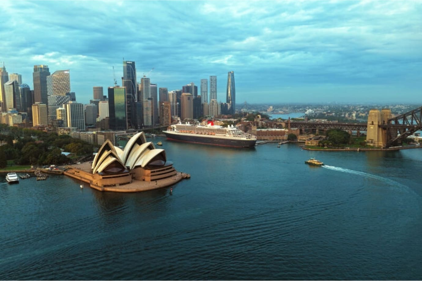 cunard cruise ship docked in sydney harbor