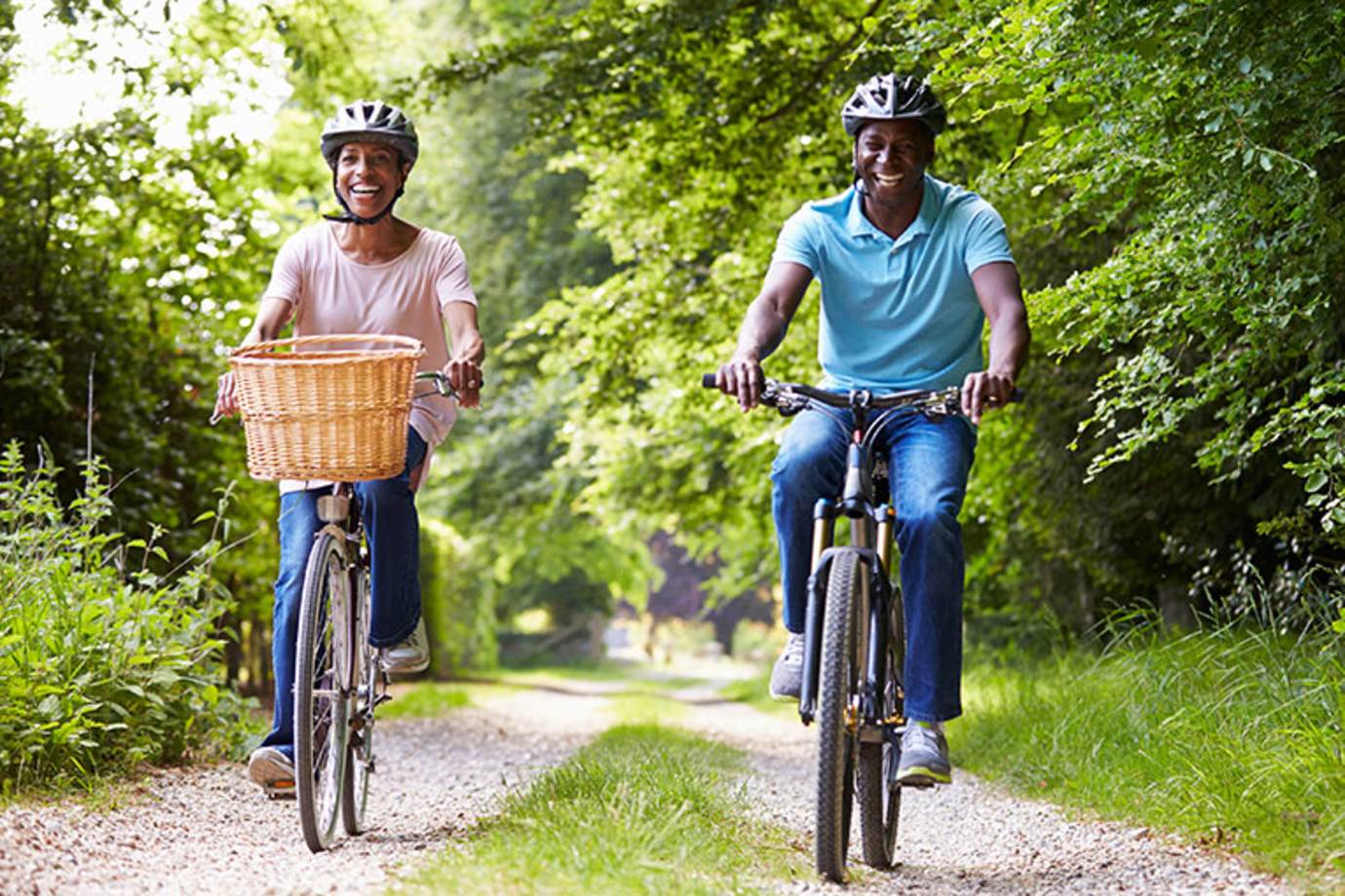 A couple with AAA Whole Life Insurance bike in the park