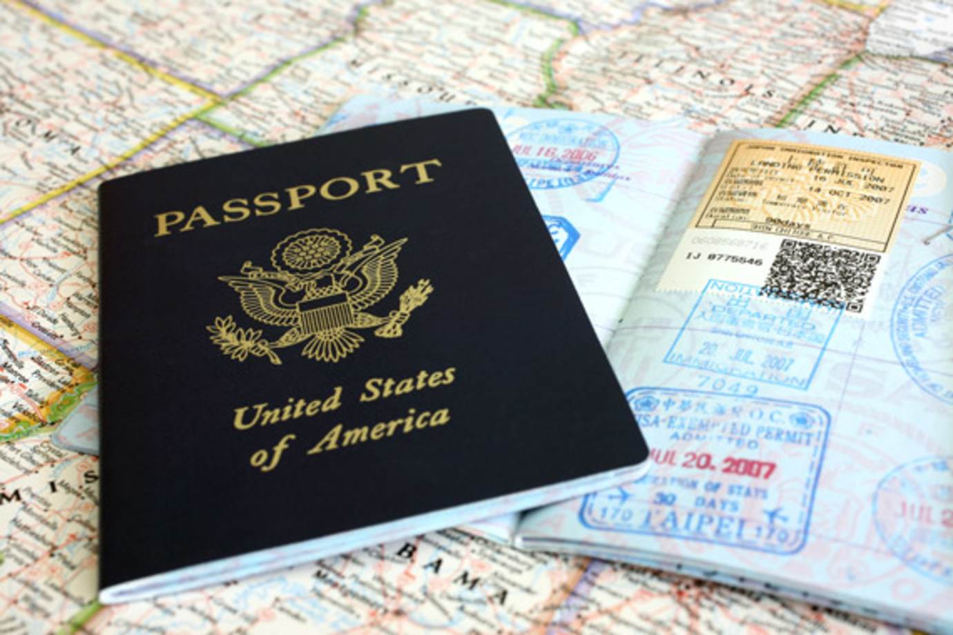 passport sitting on top of a map