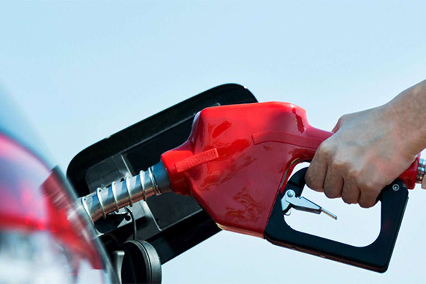 A person shown pumping gas.