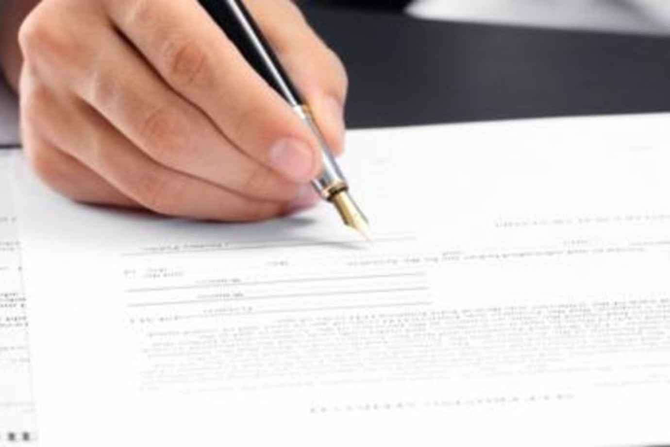 a AAA member signs DMV forms for a notary at the AAA office