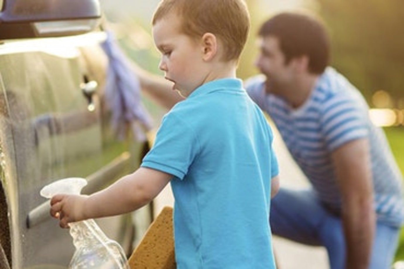a father with aaa insurance washes his car