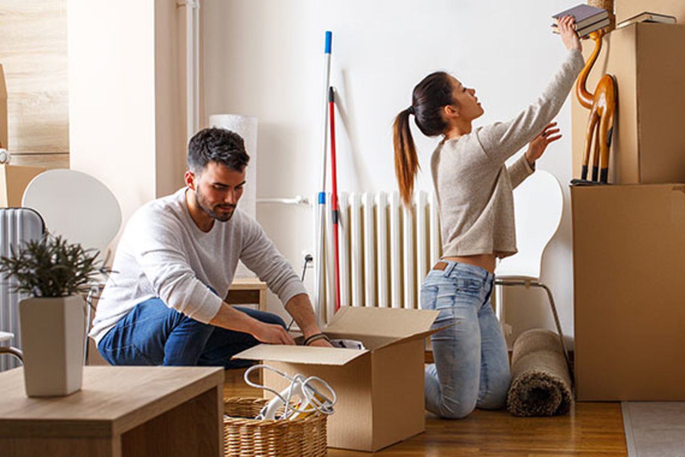 a couple unpacks boxes in their new rental