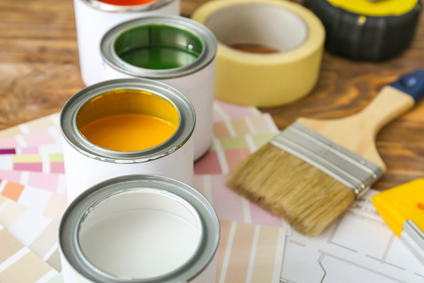 A row of colorful, open paint cans.