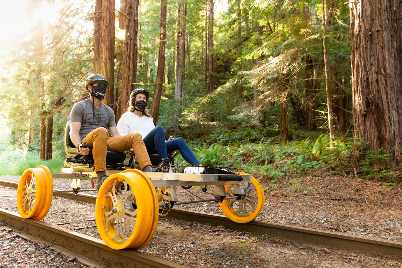 A couple ride a railbike from the Mendocino Skunk Train.