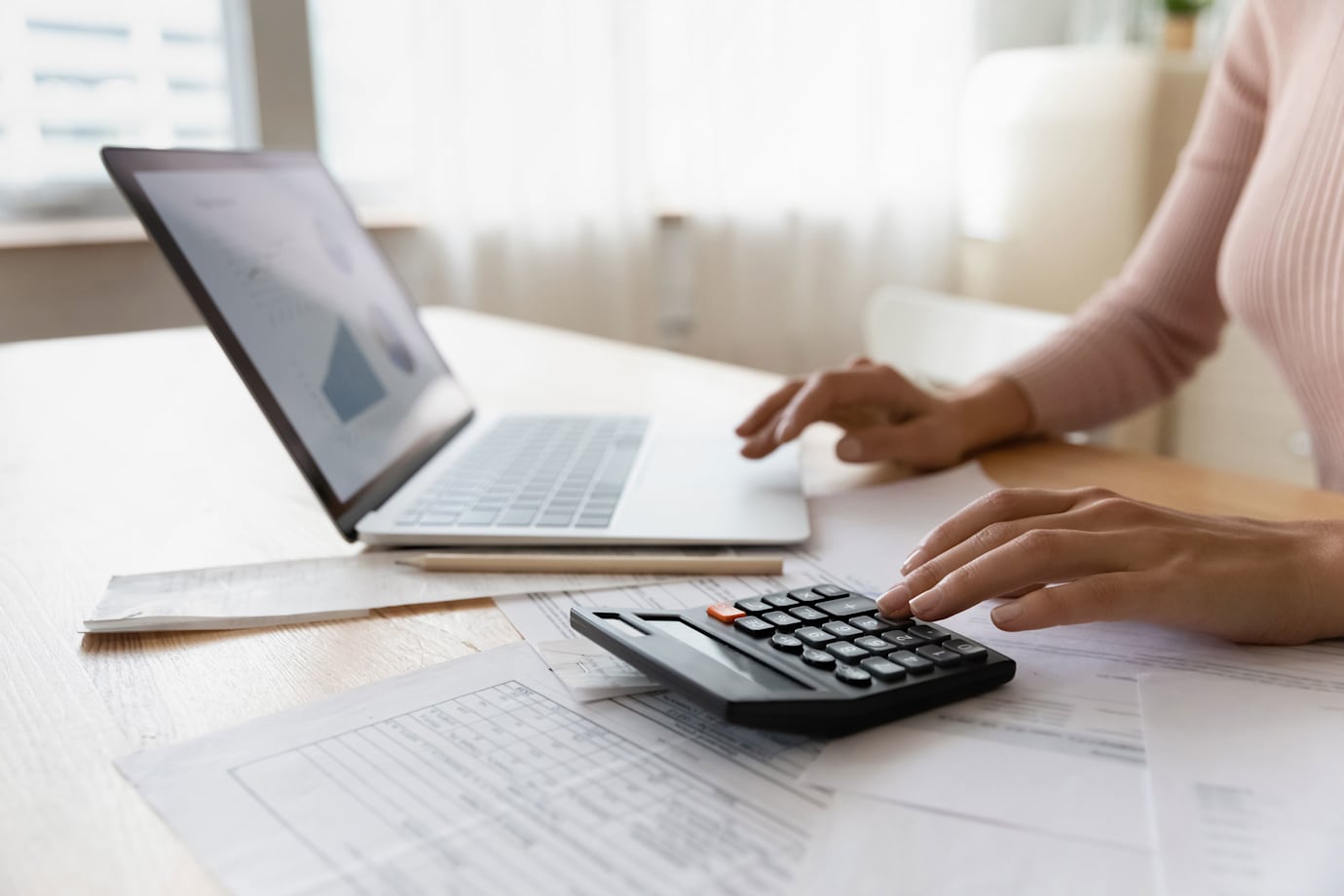 A woman reviews her credit report on her computer.
