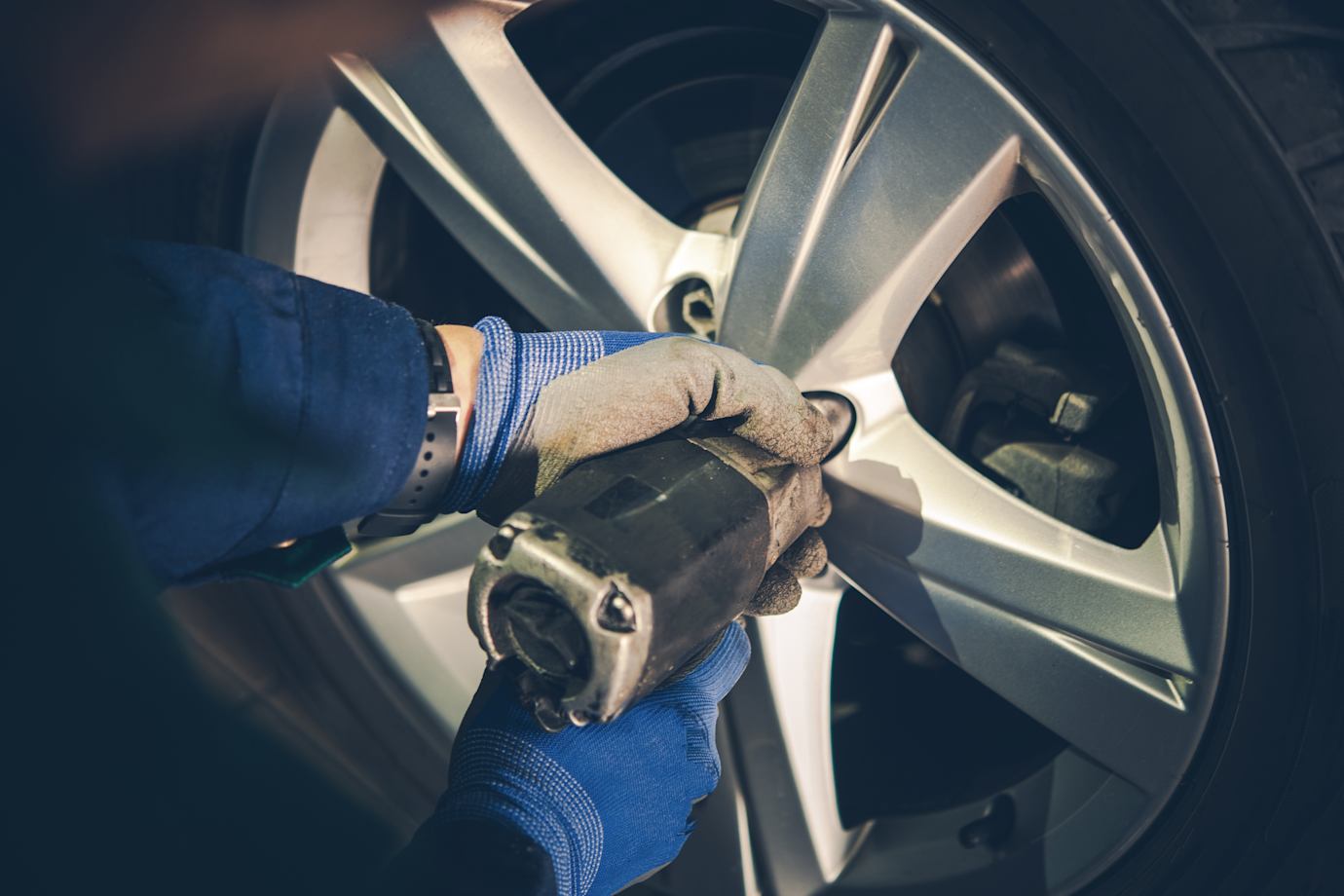 AAA ASE certified technician checking a customers tire