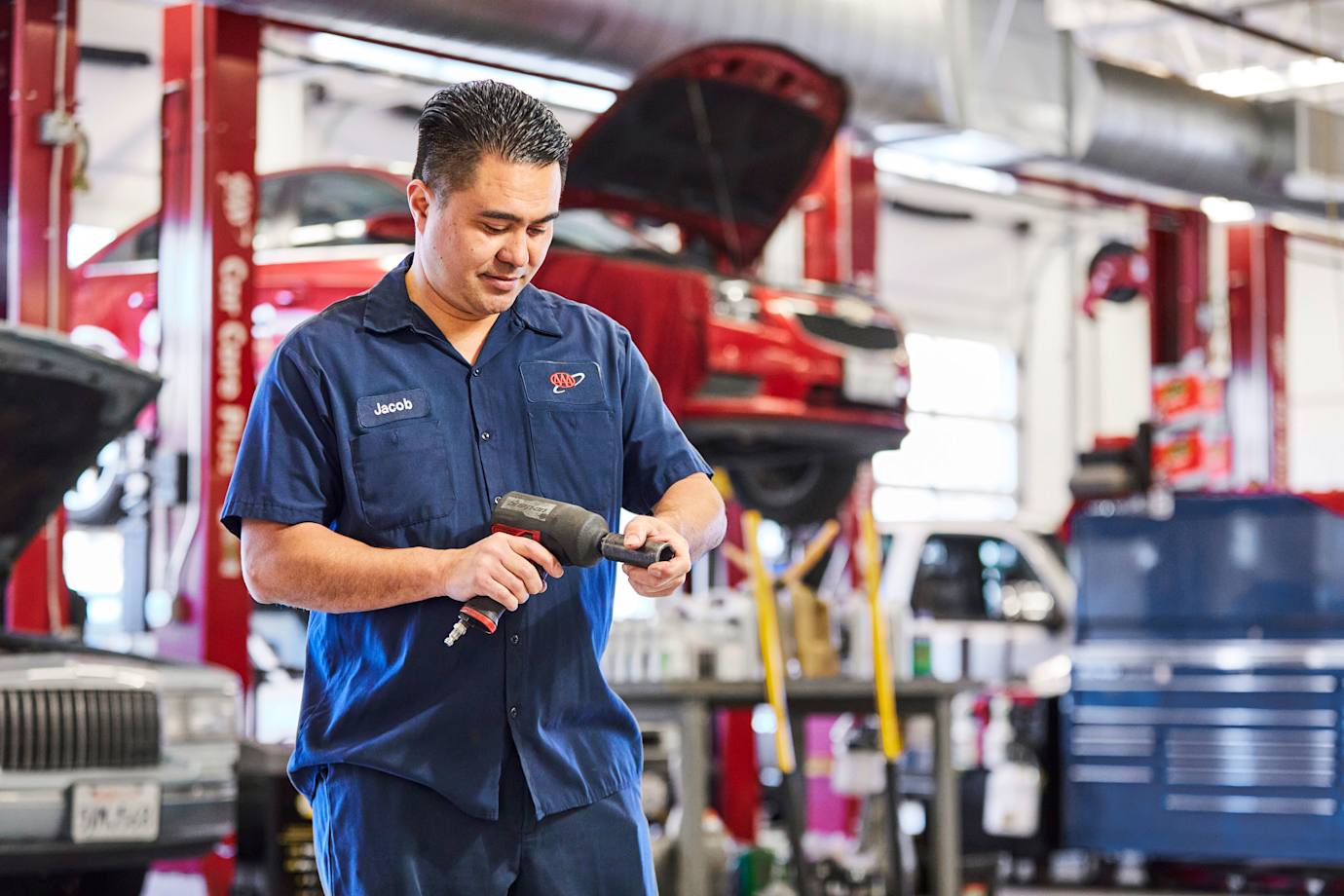 A mechanic prepares a tool in a AAA repair shop