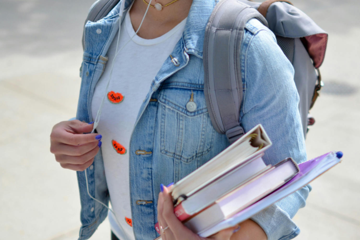 A college student with an armful of books protects themselves from identity theft scams