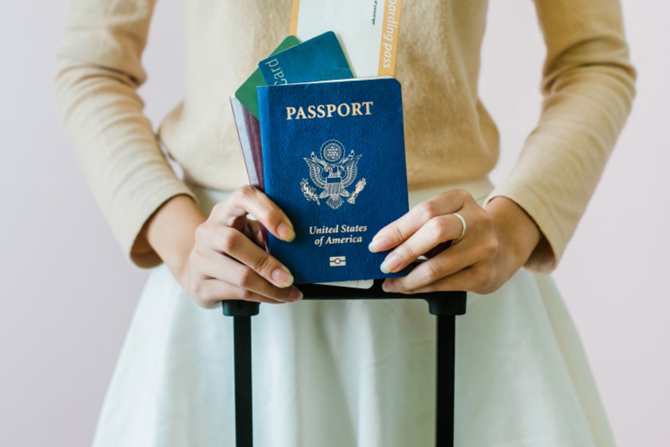 Someone with a passport gets ready to board a plane